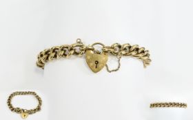 A 1950's Nice Quality 9ct Gold Curb Bracelet with attached heart shaped padlock and safety chain.