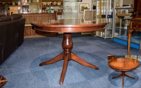 Large Multi Fuctional Dining Table Dark wood raised on a turned column with quatrefoil legs. Table
