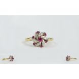 Ladies 18ct Gold Set Ruby and Diamond Cluster Ring, flowerhead setting. full hallmarked.