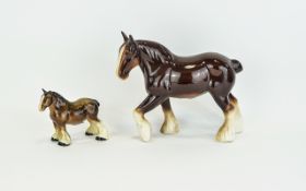 Two Ceramic Shire Horse Figures The largest, a chestnut and white mare with slightly raised left