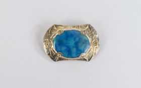 Ruskin Style Ceramic Brooch, a ceramic oval with mottled turquoise and blue glaze,