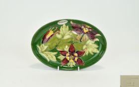 Walter Moorcroft Signed and Early Tube lined Oval Shaped Dish ' Columbine ' Design on Green Ground.