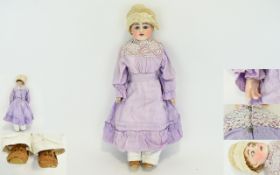 Antique Bisque Head Doll Fashioned with bisque head and shoulders with composition body.