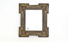 An Arts And Crafts Bevelled Edge Mirror In wood and brass frame,