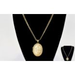 A Very Nice Quality 9ct Gold Oval Shaped Hinged Locket with Attached Long 9ct Gold Curb Chain.