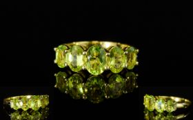 Peridot Five Stone Ring, a 1.25ct central oval cut peridot, flanked by two graduated oval peridots