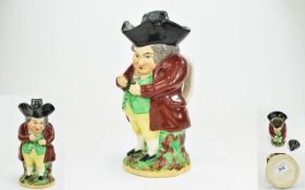 Staffordshire Early 19thC 'Snuff Taker' Toby Jug, the gentleman wearing a maroon coat,