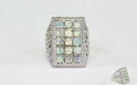 Opal Rectangular Cluster Ring, a rectangle of round cut opals, totalling 3cts, set in a criss-