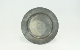 Antique Pewter Charger Small charger of plain form with impressed marks to base. Aged patina.