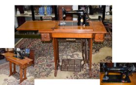 Singer Treadle and Electric Sewing Machine and Oak Cabinet. 40 Inches High.