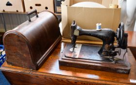 Vintage Singer Sewing Machine Traditional black and gilt machine in original box.