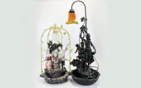 A Pair Of Reproduction Decorative Lamps The first in faux bronze effect with maiden and cherub