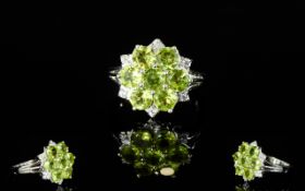 Peridot and White Zircon Floral Cluster Ring, the flower comprising seven round cut bright