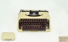 Vintage Olympia Splendid 33 Typewriter Portable typewriter in original cream plastic carry case.