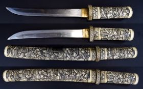 A Japanese Elaborately Carved Ivory Wakizashi Samurai Sword and Scabbard.