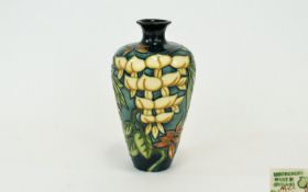 Moorcroft Collectors Club Modern Tube lined Vase. 'Yellow Wisteria' design. Designer Phillip Gibson,