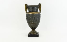 Bronzed Twin Handled Urn with classical scenes to central panel 14 inches in height.