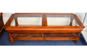 Coffee Table Large low rectangular coffee table in dark wood with bevelled glass top and woven cane