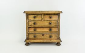 A Small Apprentice Table Top Chest of Drawers In Light Wood.