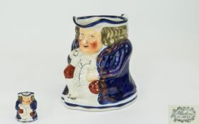 Staffordshire 'Foaming Ale' Toby Jug, c1840, typical stout jolly figure in cobalt blue coat and