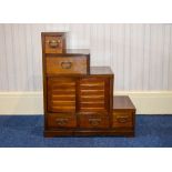 Japanese Step Tansu Hardwood Tansu Containing Four Sliding Doors And Five Drawers.