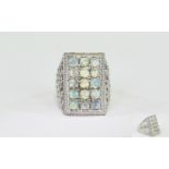 Opal Rectangular Cluster Ring, a rectangle of round cut opals, totalling 3cts, set in a criss-