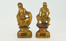 A Pair of 19th Century Soapstone Figures of Male Tribal Chiefs, Sitting and Holding Large Leaves