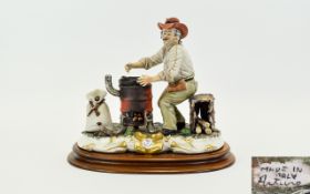Capodimonte Figure Vagrant By Wood Burning Stove Raised on an oval wooden base depicts a seated