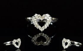Diamond Heart Ring, a cluster of baguette cut diamonds, totalling .25ct, cleverly set in the