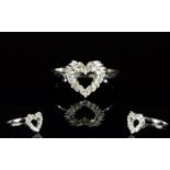 Diamond Heart Ring, a cluster of baguette cut diamonds, totalling .25ct, cleverly set in the