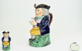 George lll Rare 18th Century Ralph Wood Type Toby Jug, seated with legs crossed, holding a jug in