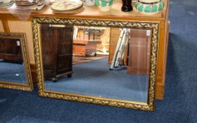 Large Bevelled Glass Mirror Rectangular mirror with foliate design dark gilt frame.