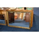 Large Bevelled Glass Mirror Rectangular mirror with foliate design dark gilt frame.