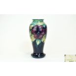 Moorcroft 'Pansy' Baluster Vase, deep blue ground to the lower part, mottled teal and cream to the