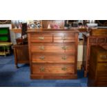 Large Dark Wood Chest Of Drawers Of plain form with five drawers and brass pull handles.