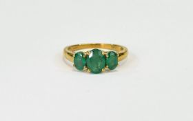 Emerald Three Stone Ring, an oval cut emerald of 1.25cts, flanked by two further oval cut