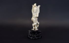 19th Century Carved Ivory Mythical Figure of a Winged Being with a Large Tongue and Large Mallet to