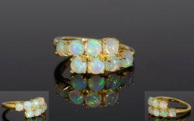 Ethiopian Opal Crossover Ring, eight round cut opals, totalling 1ct, set in a horizontal