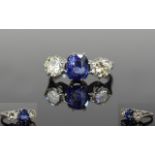 A Fine Platinum Set 3 Stone Diamond and Sapphire Ring. From the 1950's. The Central Blue Sapphire