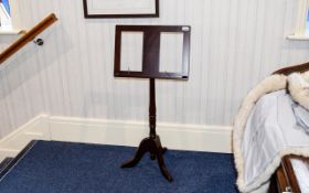 Sheet Music Stand A reproduction dark wood music stand with turned base and trefoil legs.