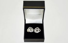 Swarovski Earrings A Pair of contemporary silver tone clip earrings in the form of two