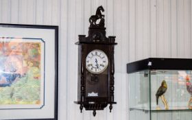 Late 19th/Early 20th Century Wall Clock, spring driven movement and pendulum. Horse finial.