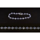 Tanzanite Cluster Tennis Bracelet, each lozenge shaped cluster comprising four round cut tanzanites,