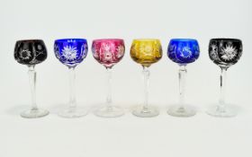 A Collection Of Six Ornate Cut Crystal Wine Glasses comprising two black glass, two cobalt glass,