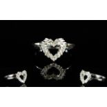 Diamond Heart Ring, a cluster of baguette cut diamonds, totalling .25ct, cleverly set in the