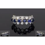 Sapphire And Diamond Dress Ring, Set With Two Rows Of 14 Round Modern Brilliant Cut Diamonds Between