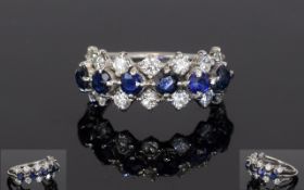 Sapphire And Diamond Dress Ring, Set With Two Rows Of 14 Round Modern Brilliant Cut Diamonds Between