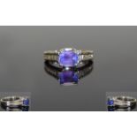 18ct White Gold Single Stone Tanzanite and Baguette Cut Diamond Ring. The Emerald Cut Tanzanite