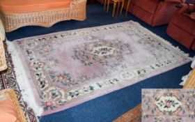 Oriental Wool Rug Pale powder pink rug with cream, dark pink, and green floral and foliate border.