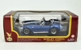 A 1964 Navy and White Shelby Cobra 427S/C Car Model. Made of Die Cast Metal With Some Plastic Parts.